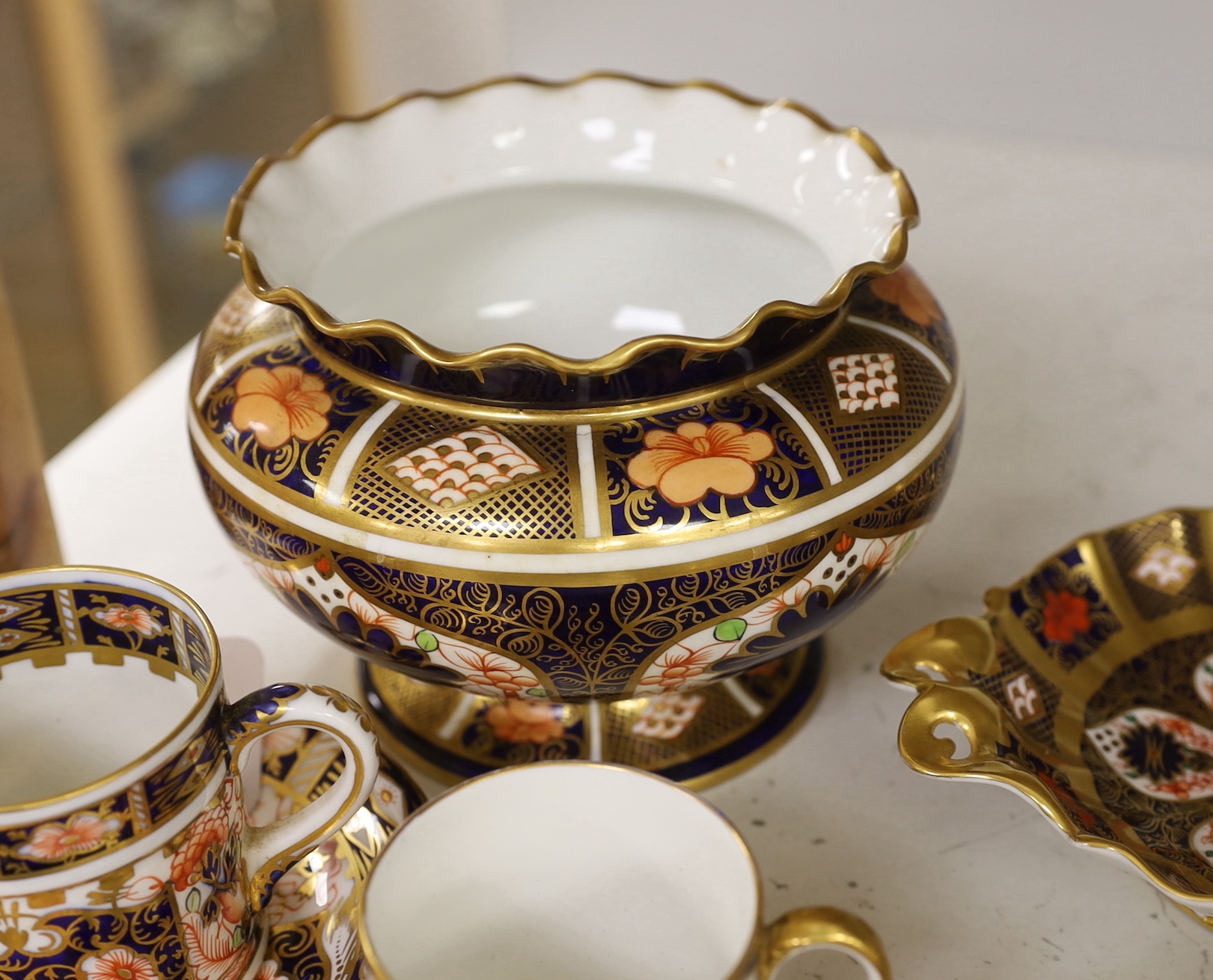 A Royal Crown Derby spherical vase with pie crust rim painted with pattern 1128, a two handled dish in the same pattern, five cups and three saucers in pattern 2451